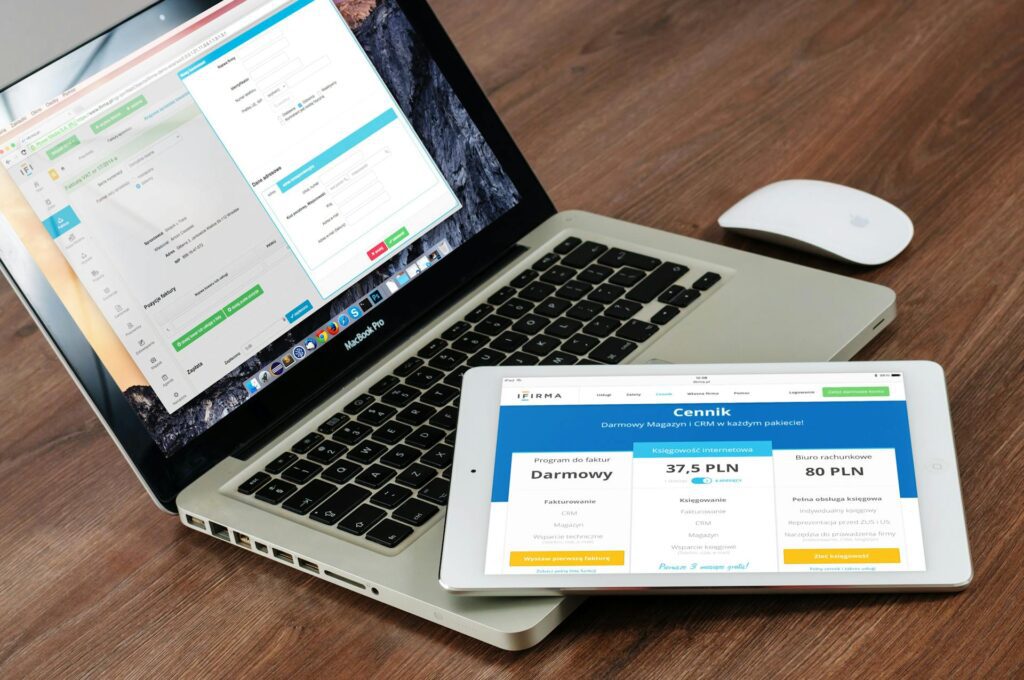Laptop and tablet displaying financial and business dashboards.