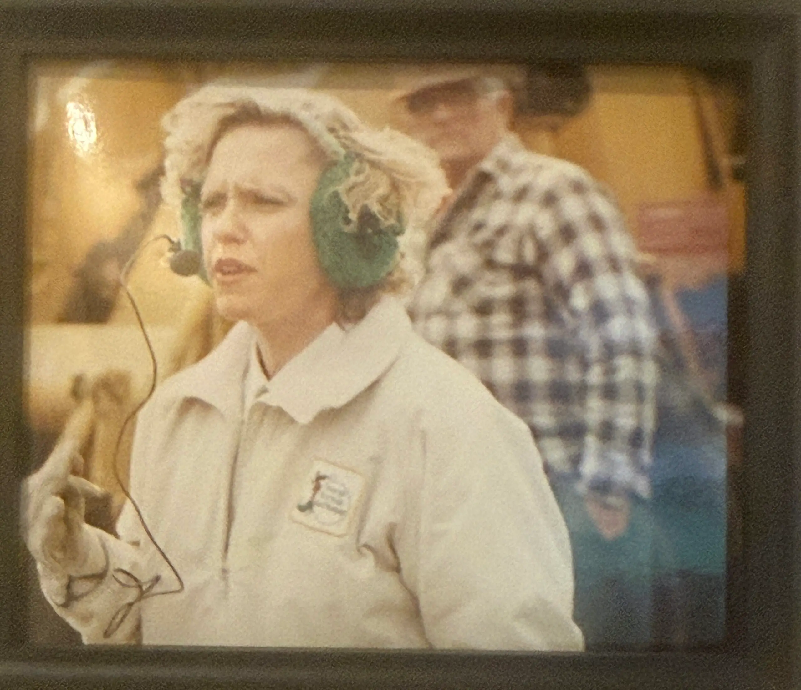 Person wearing earmuffs and headset microphone